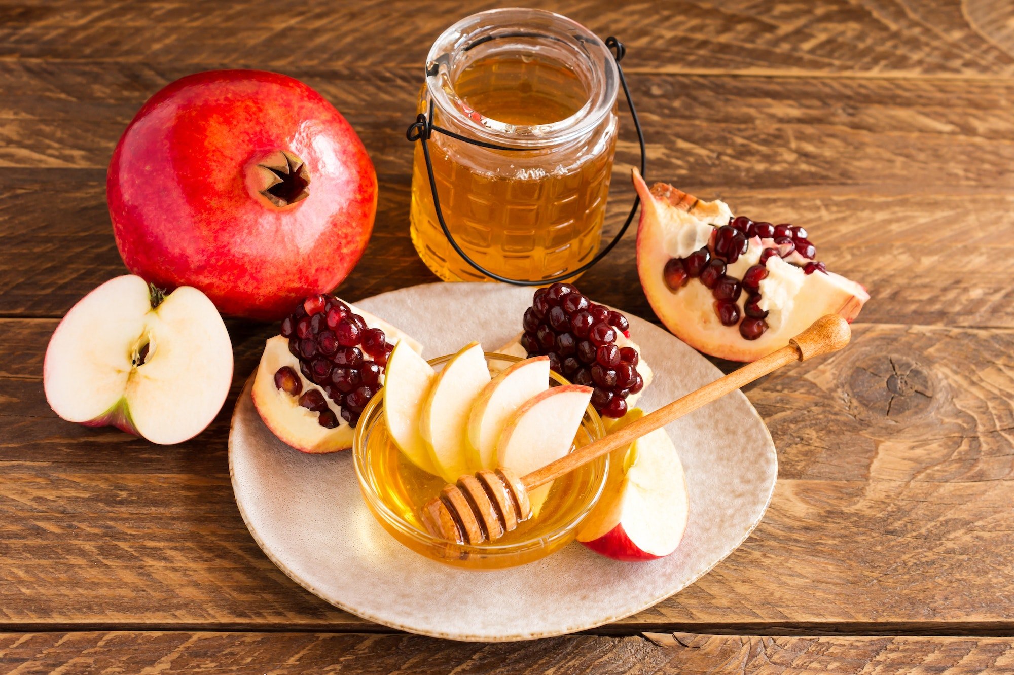 Pomegranate, apple and honey, traditional food of jewish New Year celebration, Rosh Hashana ראש השנה