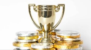 a-gold-trophy-surrounded-by-prize-money-for-the-wi-9MTADJJ-scaled-e1622101436732
