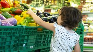 child-shopping-peppers-in-supermarket-concept-for-E8MX99J-scaled