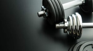 the-metal-dumbbell-and-weights-P3J5ZMR-scaled-e1621776473539